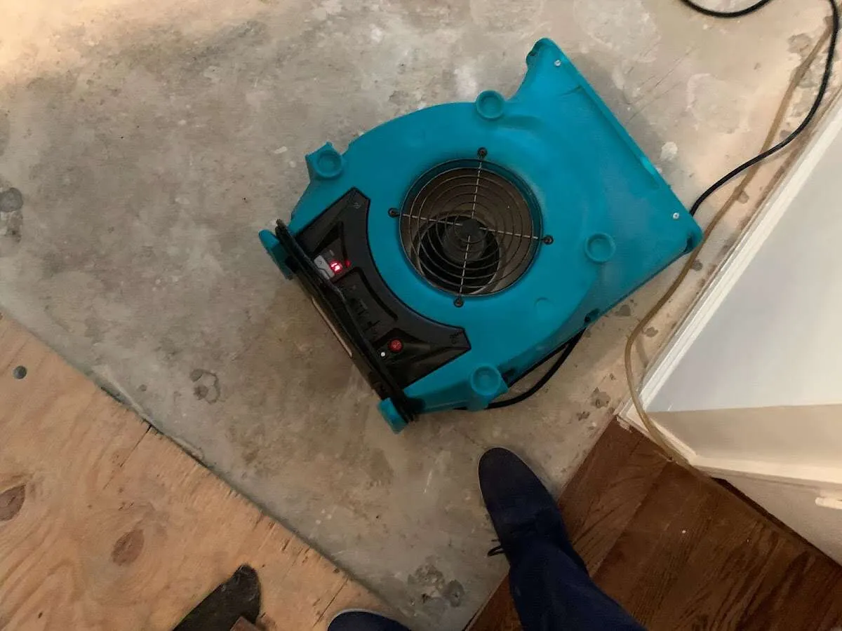 Air mover drying subfloor during Leak Detection & Repair in College Station